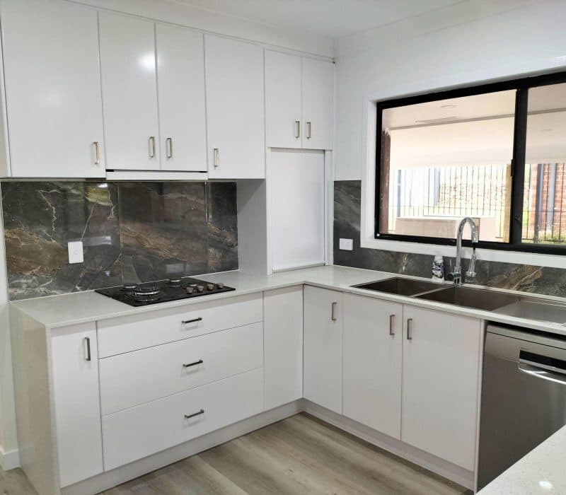 White kitchen with dramatic book-matched stone splashback