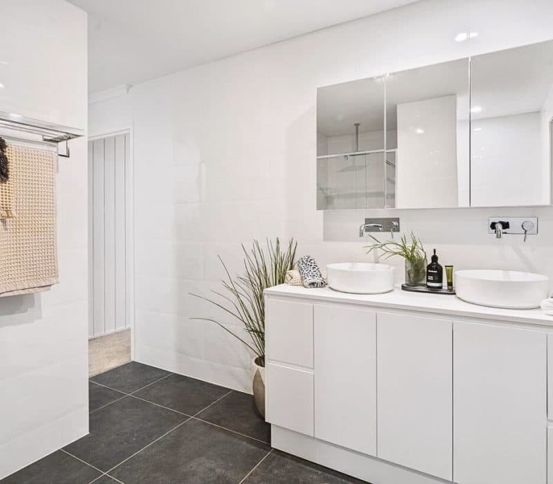Compact white bathroom with floating vanity at Strathburn Street