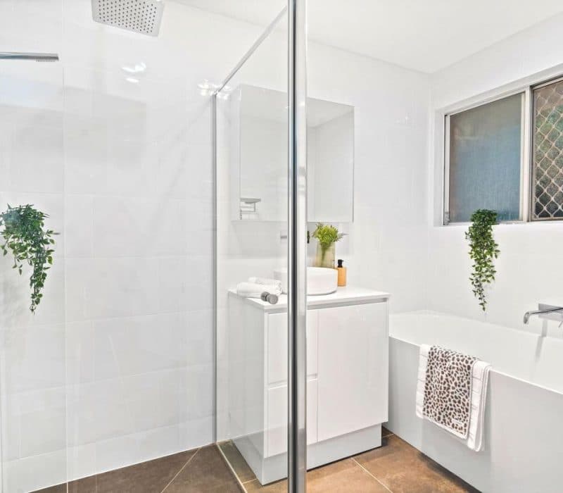 Bright white bathroom with twin vessel basins at Strathburn Street