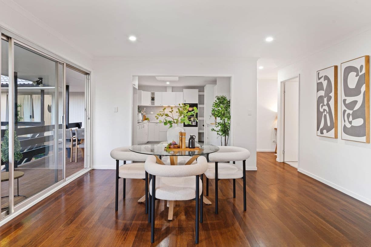 Open dining and kitchen with timber floors