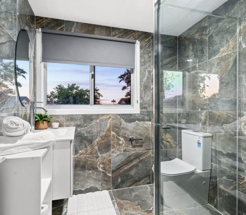 Grey marble bathroom with sunset view at Tingatel Street